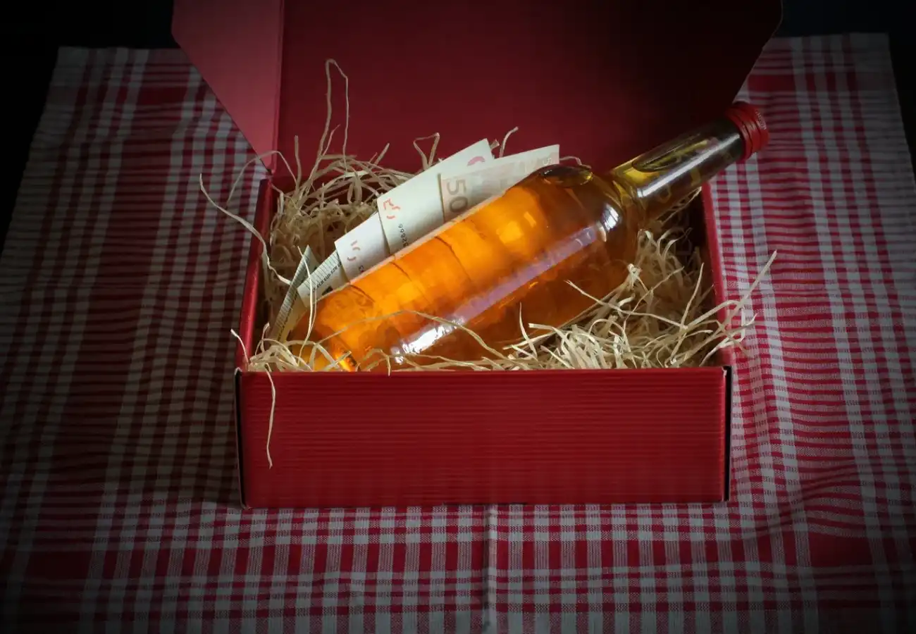 Amber liquor bottle in red gift box