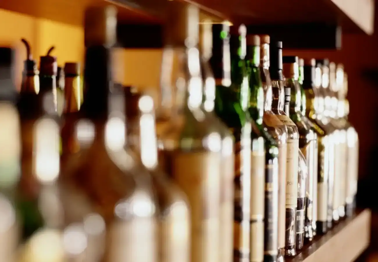 A row of bottles on display in front of the camera.